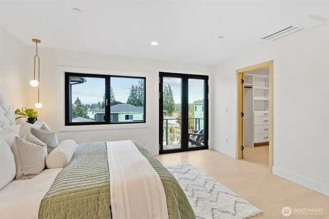 a bedroom with a bed and a large window