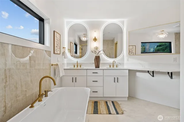 a spacious bathroom with a sink a mirror and a bathtub