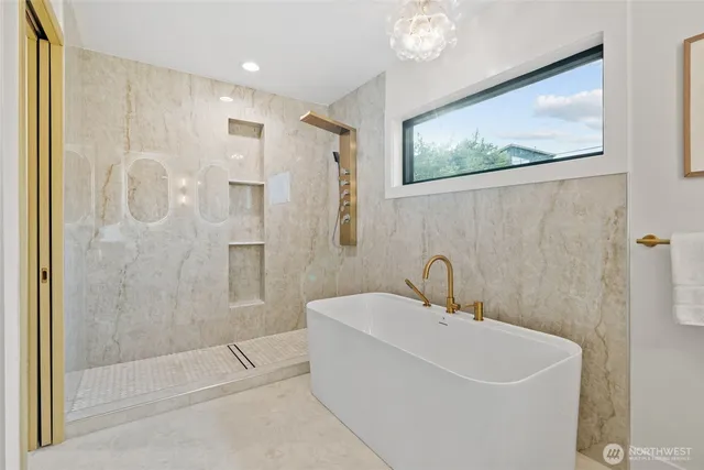 a white bath tub sitting next to a shower