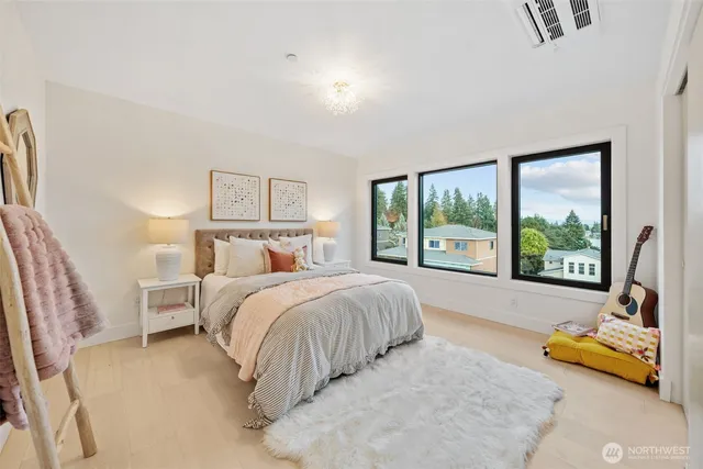 a bed sitting in a bedroom next to a large window