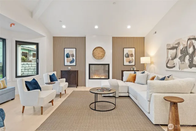 a living room with furniture a rug and a large window