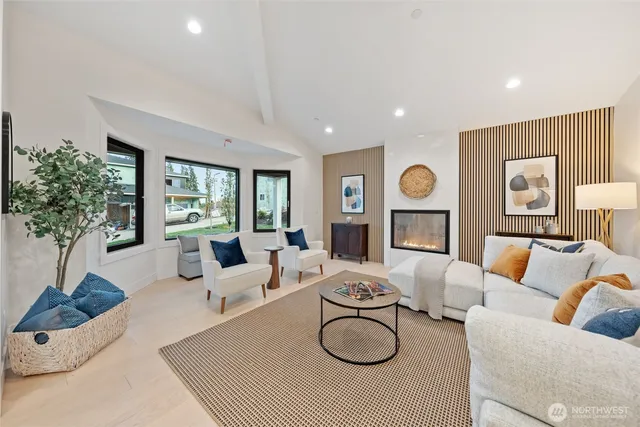 a living room with fireplace furniture and a large window