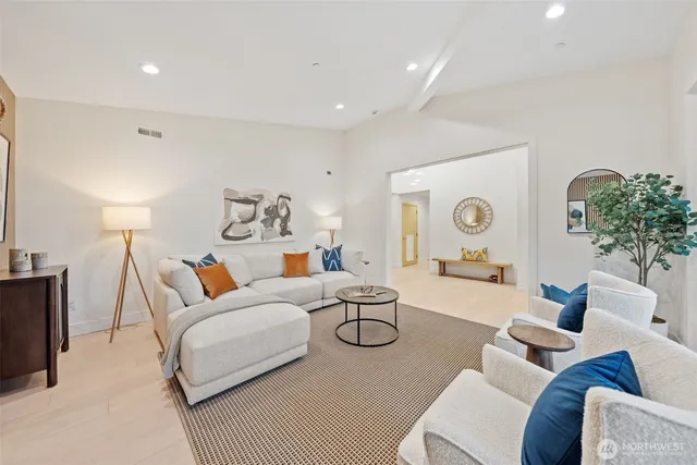 a living room with furniture and potted plant