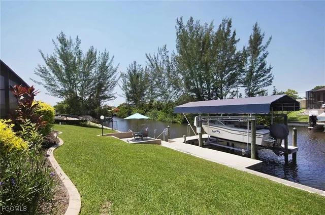 an aerial view of a house with a yard and lake view