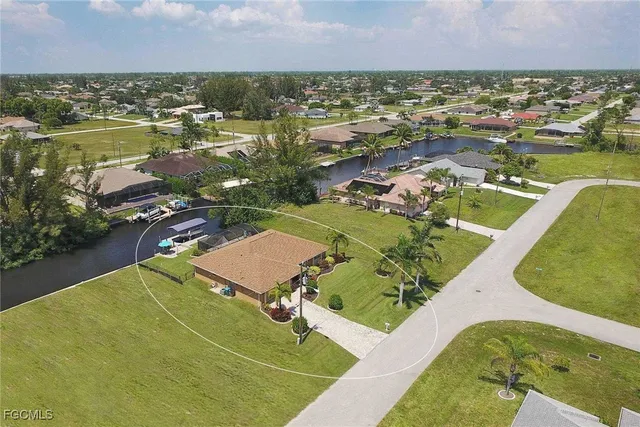 an aerial view of a house with garden space and lake view