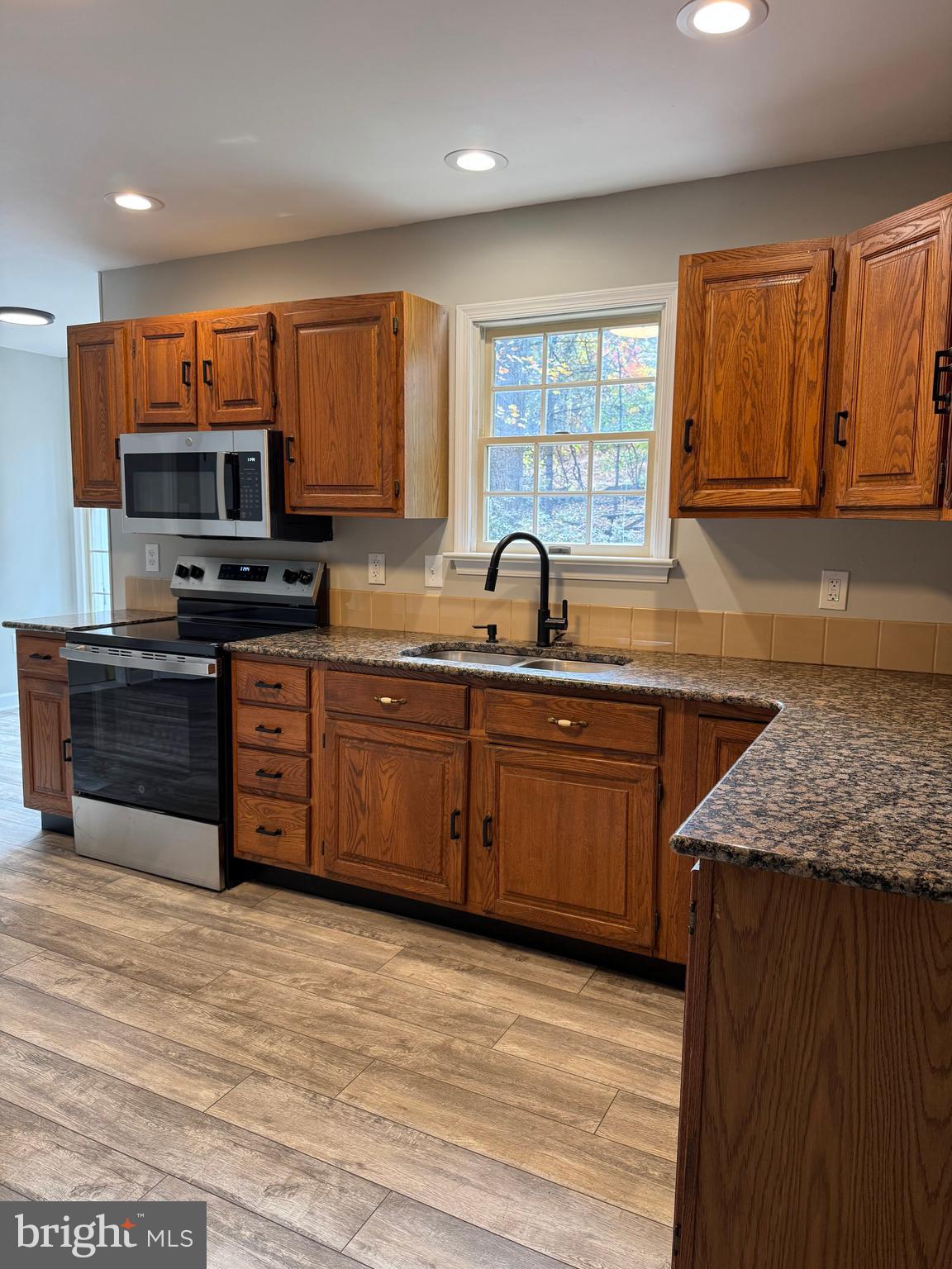 200 Mountain Road Lewisberry, PA 17339 - Photo 3 of 31 a kitchen with stainless steel appliances granite countertop a sink a stove and a microwave