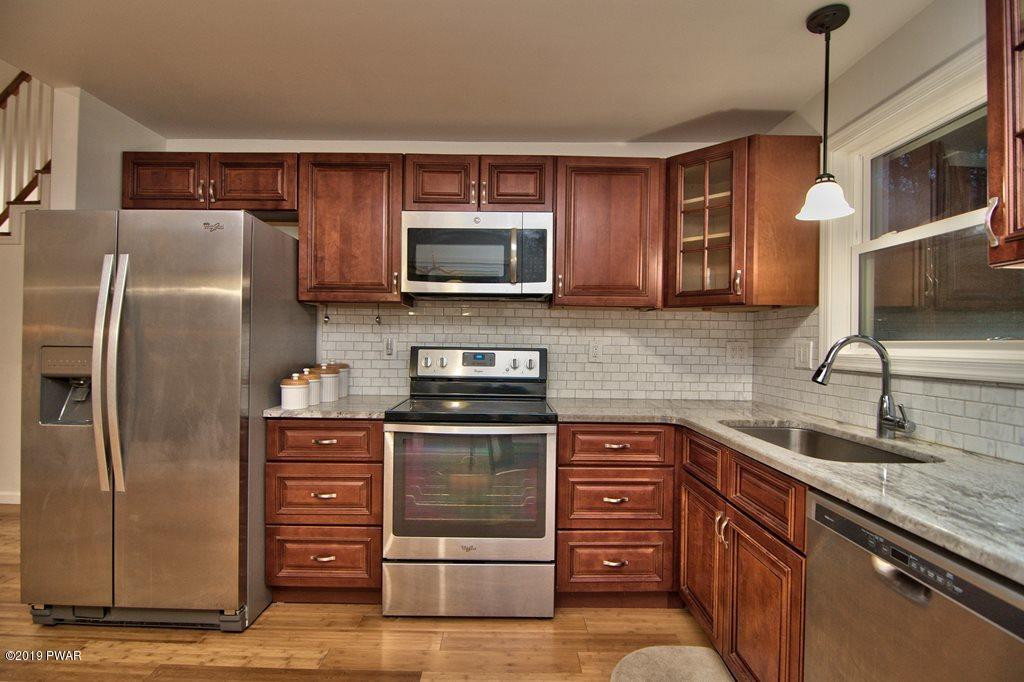 3145 Northgate Road Lake Ariel, PA 18436 - Photo 7 of 78 a kitchen with stainless steel appliances granite countertop a refrigerator microwave and sink