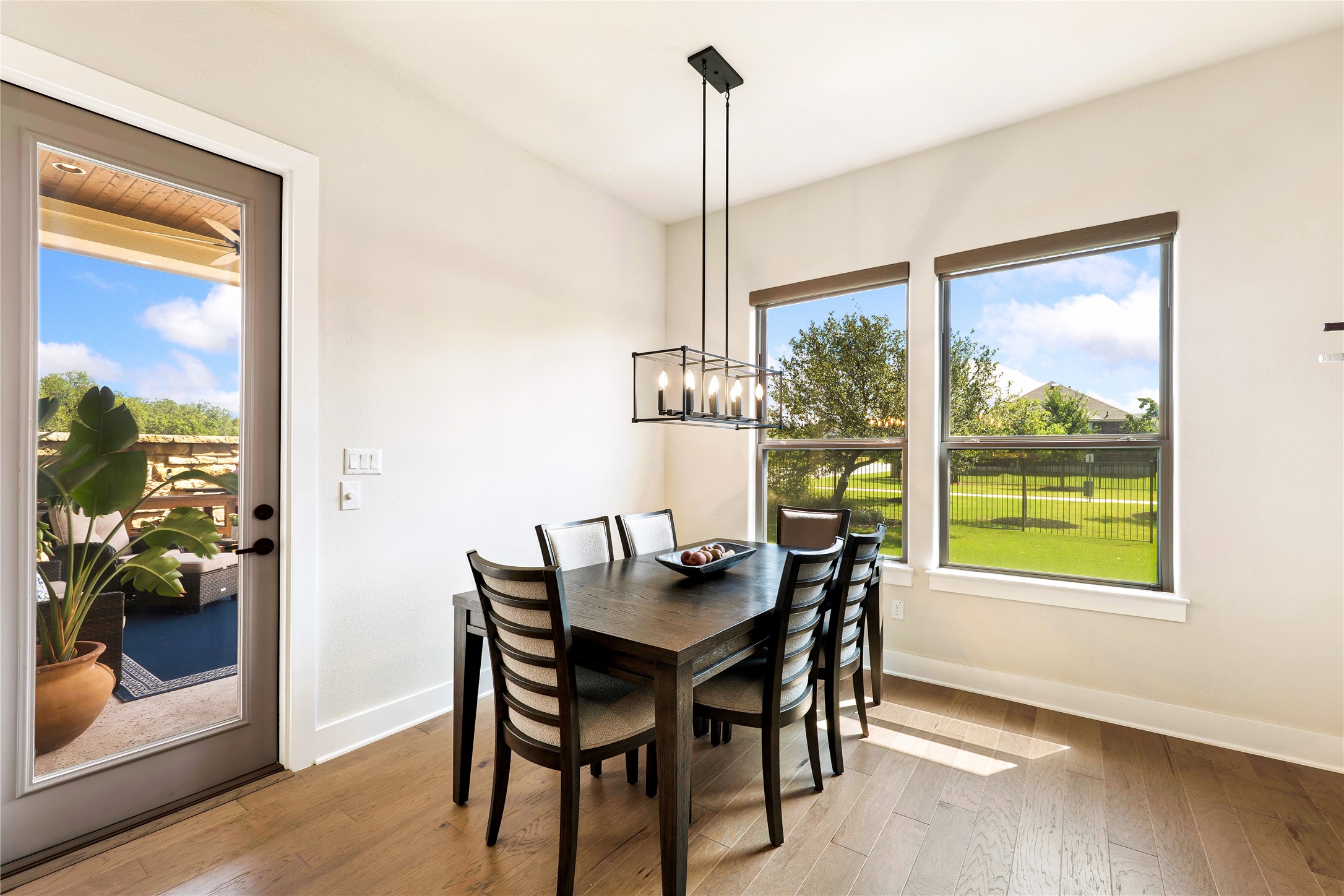 2408 Nate's Place Georgetown, TX 78633 - Photo 14 of 40 Dining area featuring hardwood floors and generous windows illuminate this inviting dining area, perfect for gatherings.