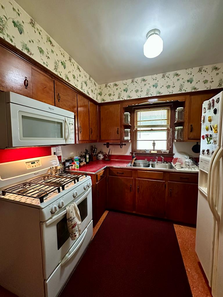 3042 Colonial Drive Columbus, GA 31903 - Photo 16 of 29 a kitchen with granite countertop a stove and a sink