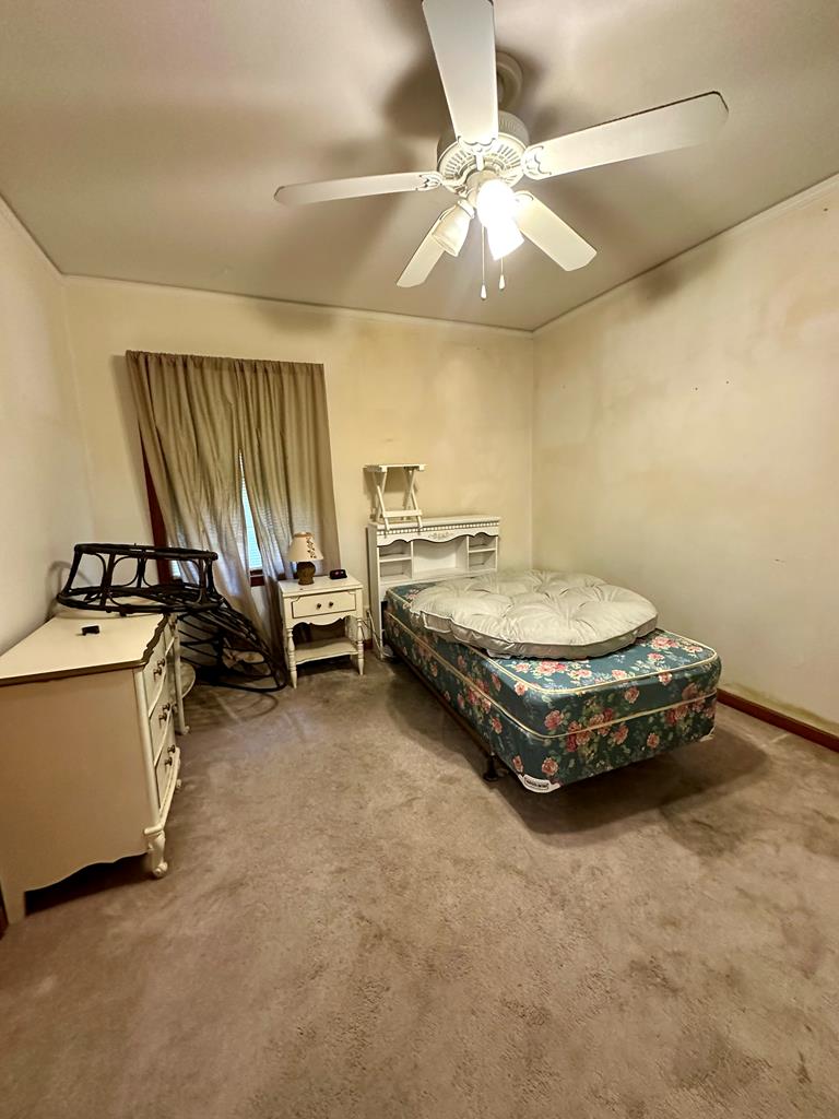 3042 Colonial Drive Columbus, GA 31903 - Photo 20 of 29 a spacious bedroom with a bed and a chandelier