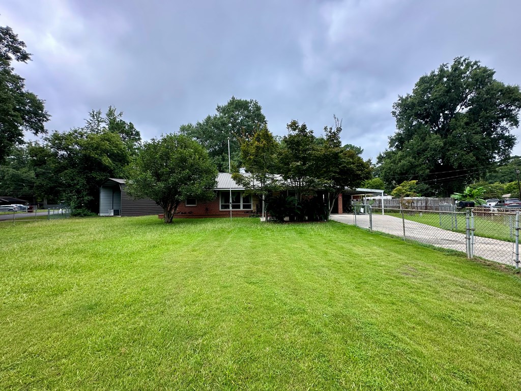 3042 Colonial Drive Columbus, GA 31903 - Photo 2 of 29 a view of a house with backyard and a garden