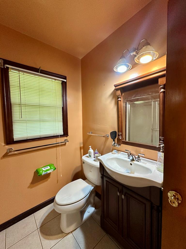 3042 Colonial Drive Columbus, GA 31903 - Photo 23 of 29 a bathroom with a toilet a sink and mirror