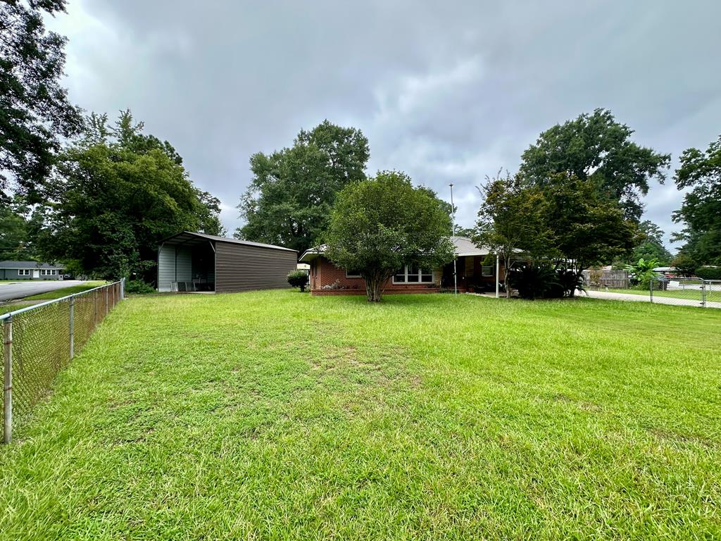 3042 Colonial Drive Columbus, GA 31903 - Photo 4 of 29 a backyard of a house with lots of green space
