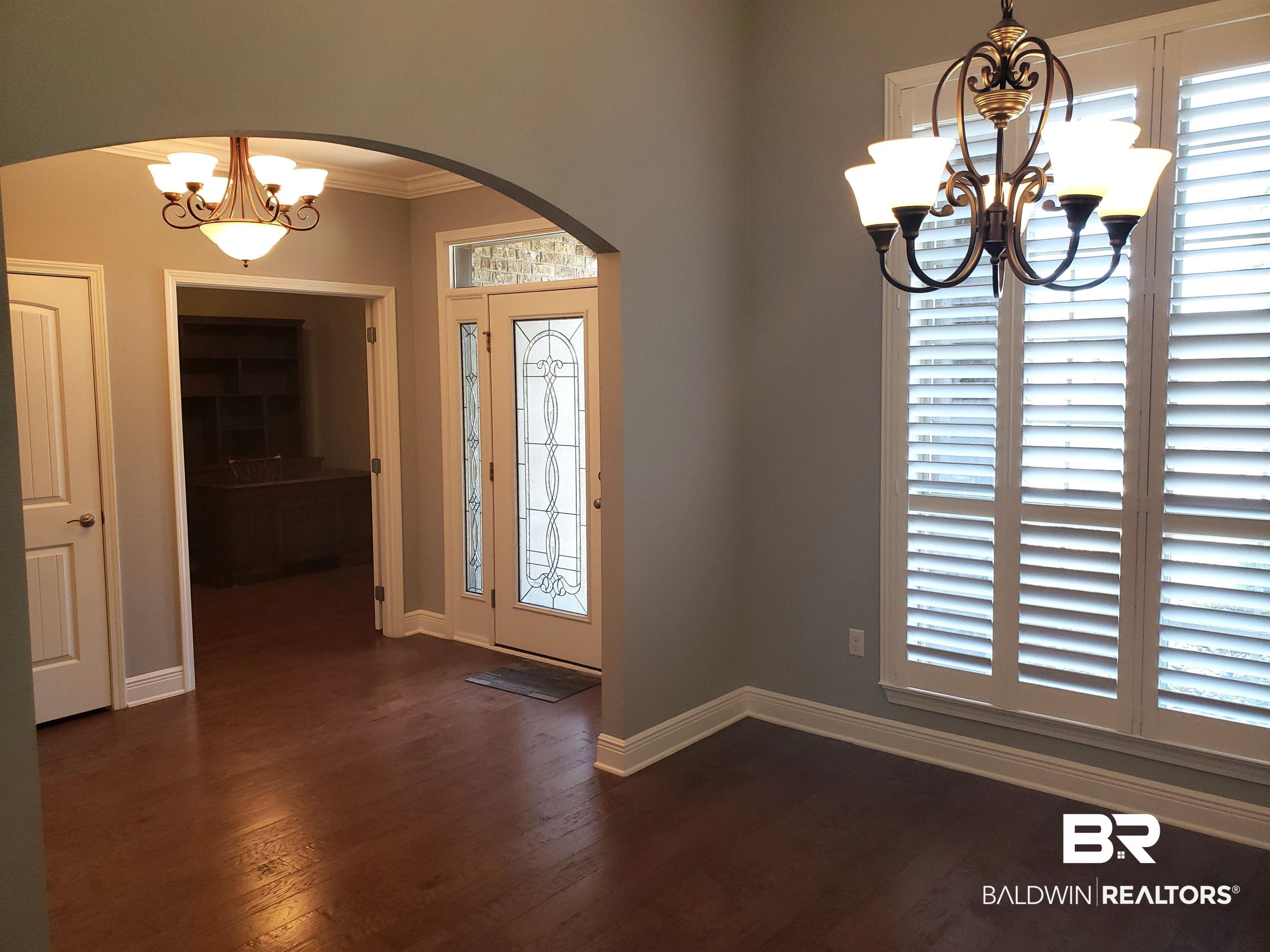 23373 Dundee Circle Foley, AL 36535 - Photo 6 of 34 Foyer featuring ornamental molding, dark hardwood / wood-style flooring, and an inviting chandelier