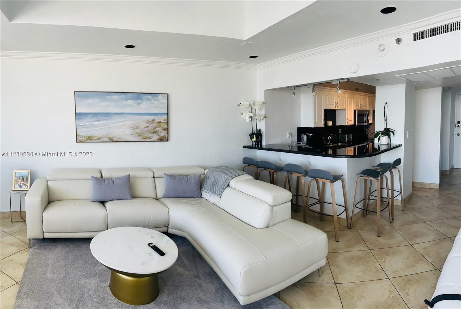 100 Lincoln Road, Unit 1612 Miami Beach, FL 33139 - Photo 9 of 12 a living room with furniture a rug and a painting on the wall