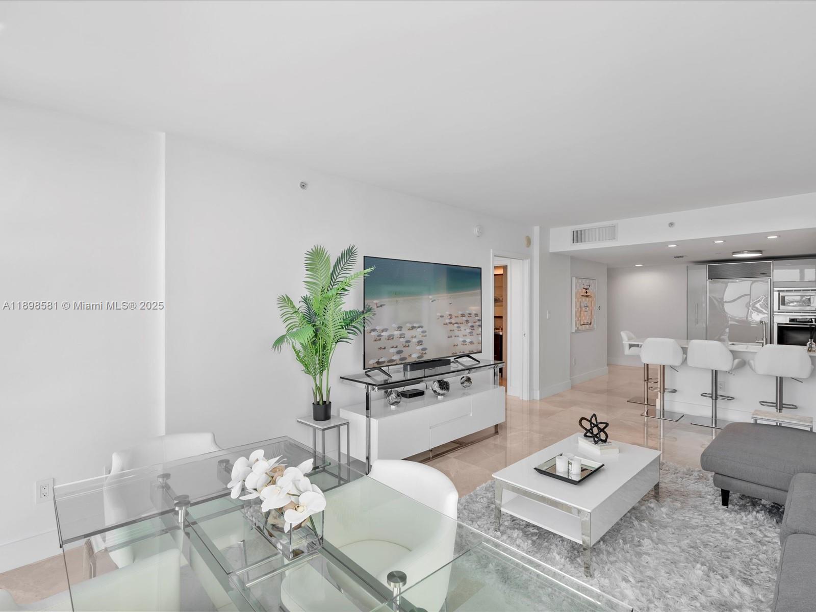 6801 Collins Avenue, Unit 1402 Miami Beach, FL 33141 - Photo 12 of 50 a living room with furniture a rug and a table