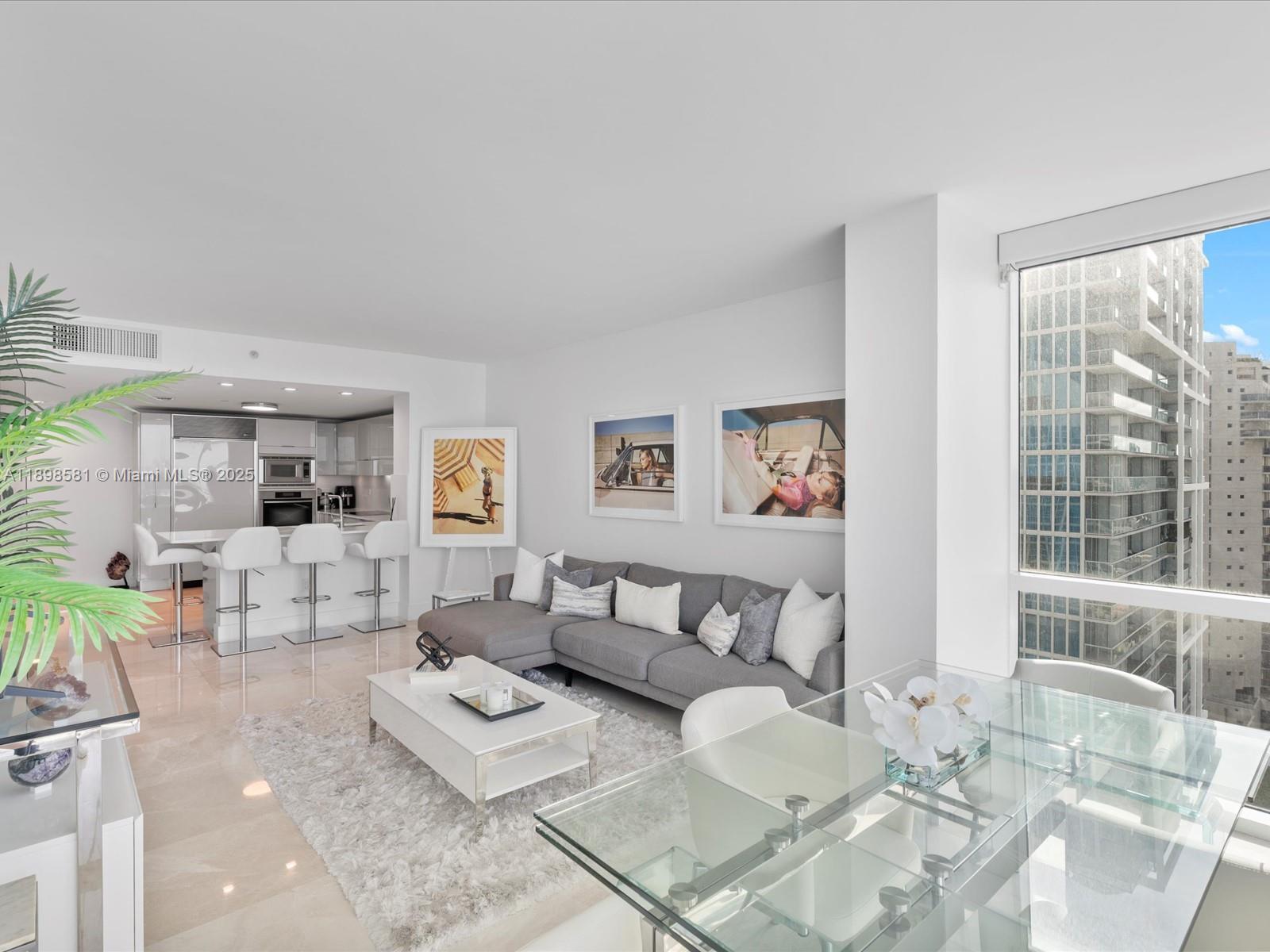 6801 Collins Avenue, Unit 1402 Miami Beach, FL 33141 - Photo 14 of 50 a living room with furniture and a large window