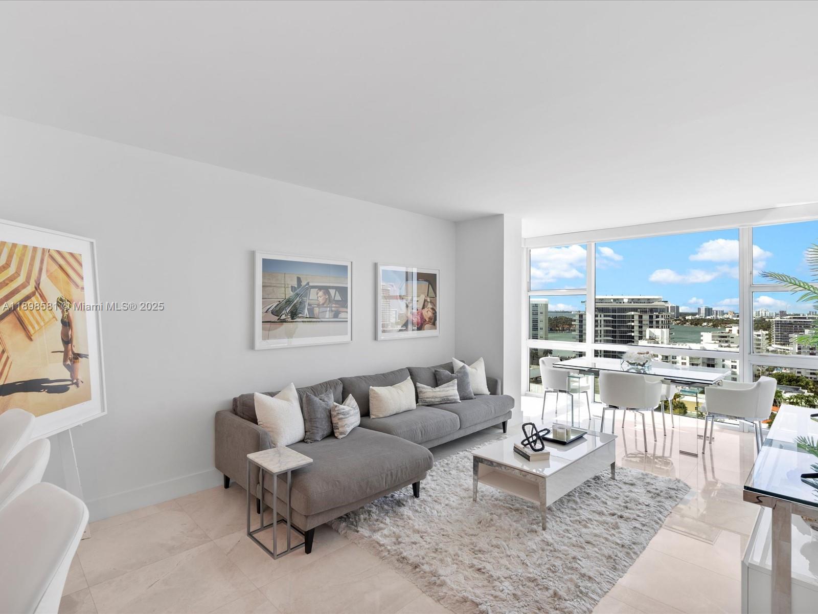 6801 Collins Avenue, Unit 1402 Miami Beach, FL 33141 - Photo 15 of 50 a living room with furniture and a large window