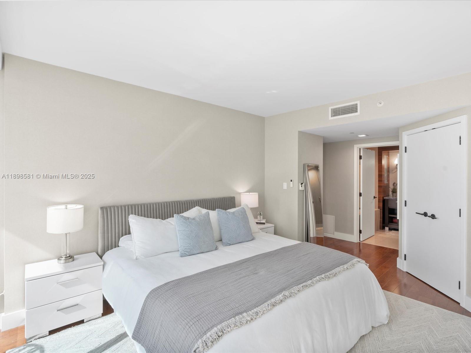 6801 Collins Avenue, Unit 1402 Miami Beach, FL 33141 - Photo 25 of 50 a bedroom with a bed and a lamp