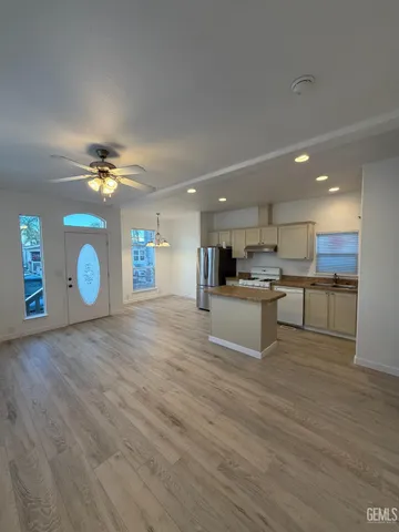 a view of kitchen with kitchen island microwave and stove