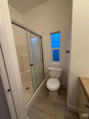 a bathroom with a toilet and a shower