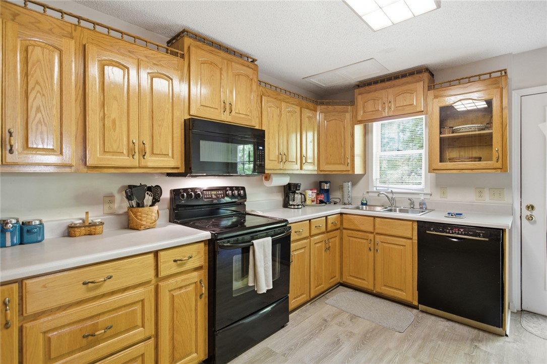 110 Snug Harbor Road Seneca, SC 29678 - Photo 9 of 37 This spacious kitchen offers ample cabinet storage and a practical layout for daily living.