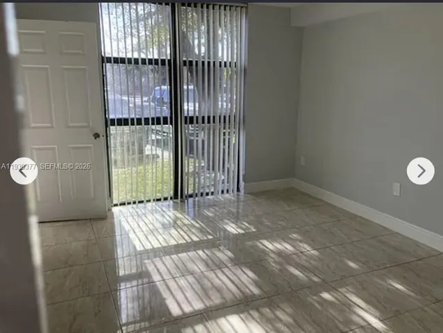 a view of an empty room with glass door