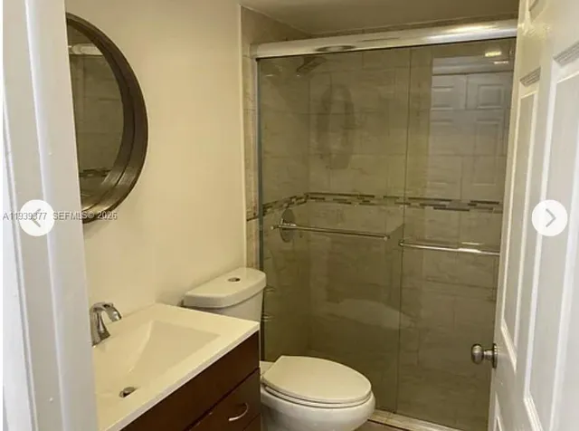 a bathroom with a shower a toilet and sink