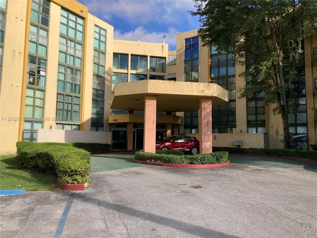 a front view of a building with a garden