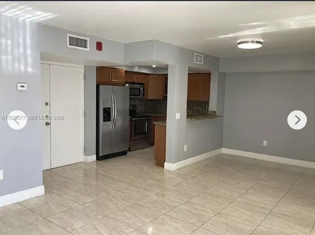 an empty room with closet and windows
