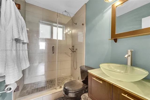 a bathroom with a sink toilet and shower