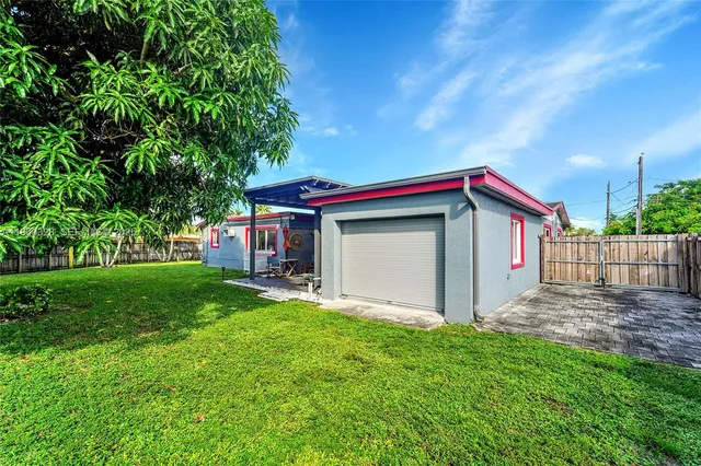 a view of backyard of house with green space