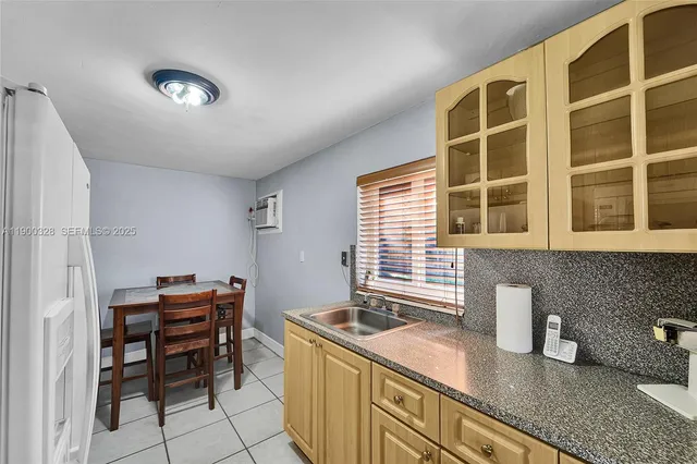 a kitchen with granite countertop a sink and a stove
