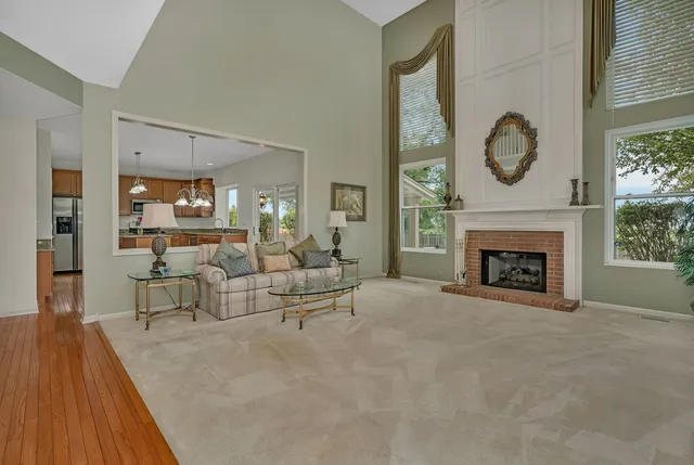 a view of living room with furniture and a fireplace