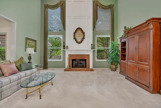 a kitchen with granite countertop wooden cabinets a dining table and chairs