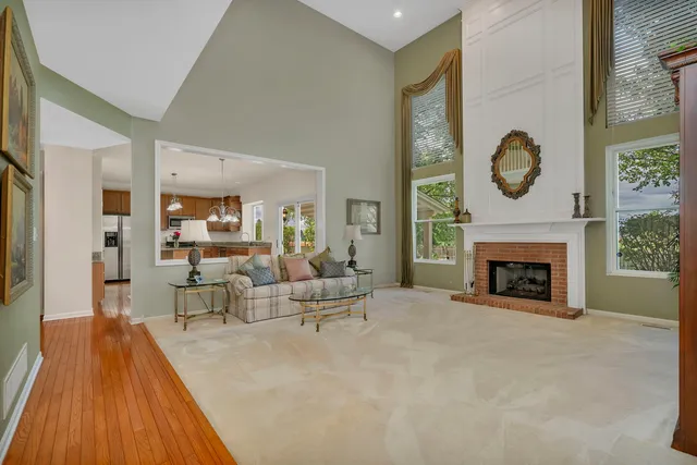 a kitchen with kitchen island a stove a refrigerator a sink dishwasher with a dining table and chairs