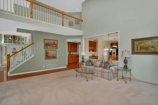 a kitchen with stainless steel appliances granite countertop a sink dishwasher a stove and a refrigerator with wooden floor