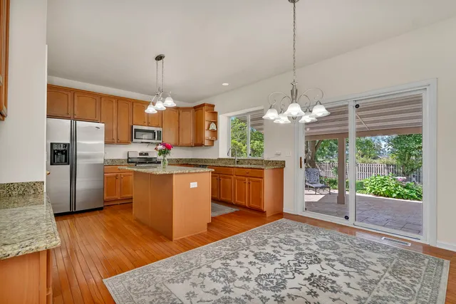 a view of a dining room with furniture and chandelier