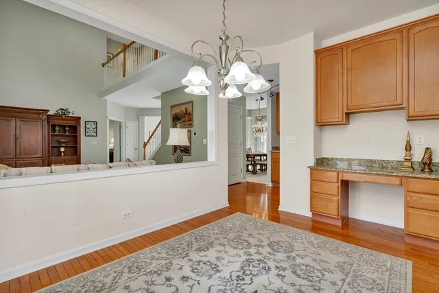a view of a dining room with furniture and chandelier