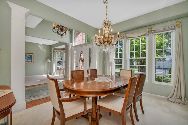 a spacious bathroom with a tub sink and mirror