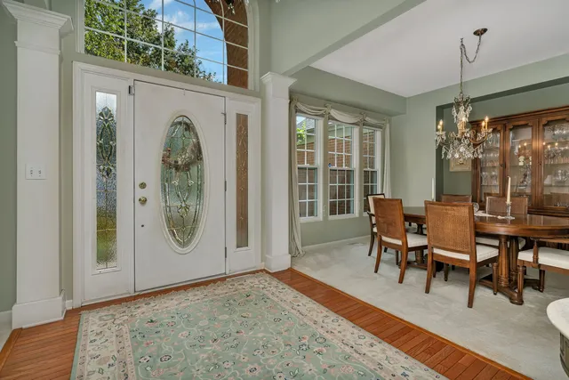 a view of a livingroom with wooden floor and a large window