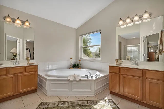 a view of a house with backyard and chairs