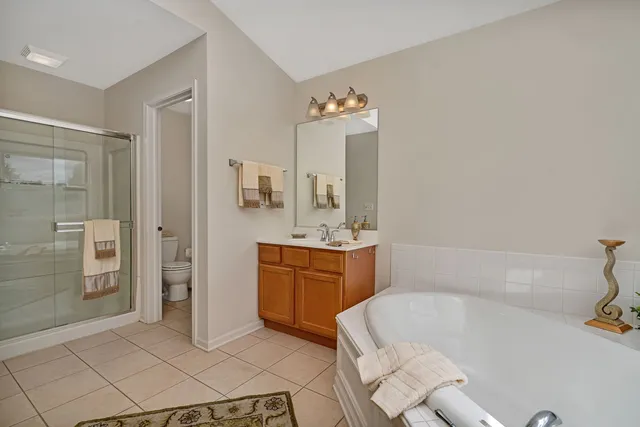 a view of a patio with table and chairs potted plants with floor to ceiling window