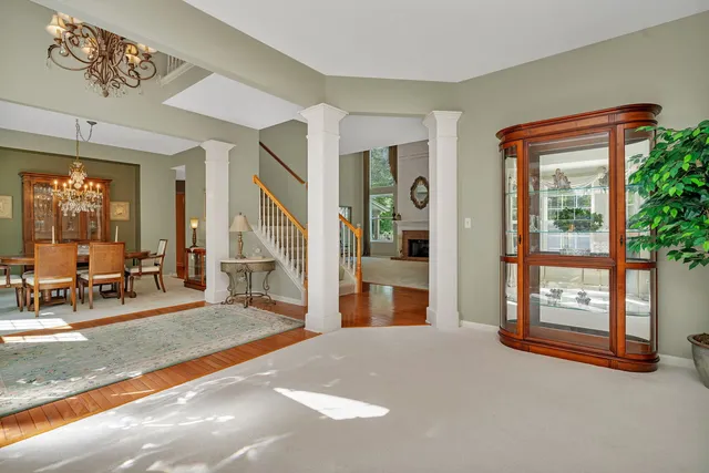 a view of a livingroom with furniture wooden floor and windows