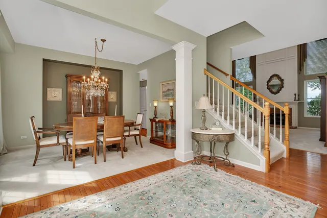 a living room with furniture a clock and a fireplace