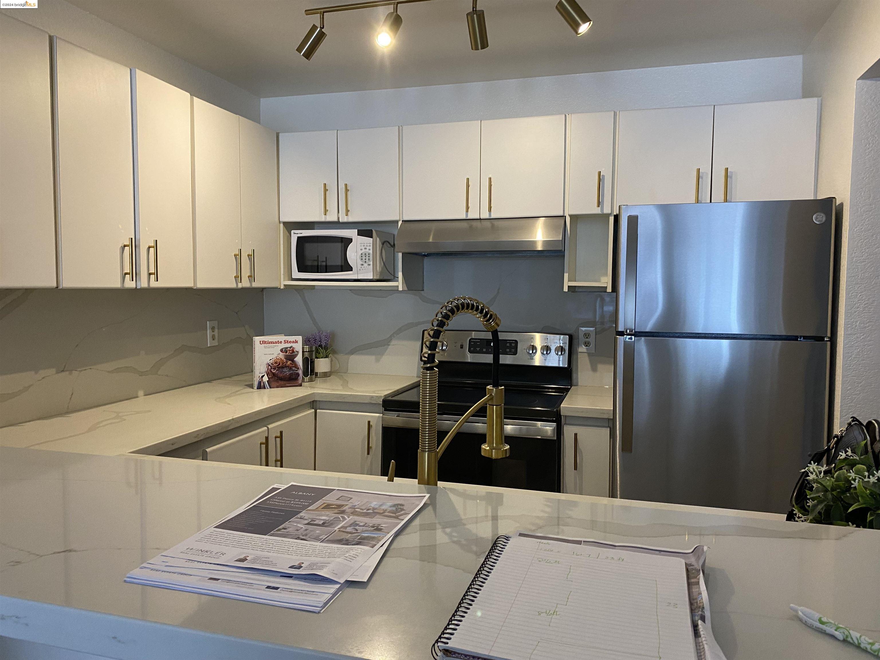535 Pierce Street, Unit 1114 Albany, CA 94706 - Photo 1 of 1 a kitchen with a refrigerator and a sink