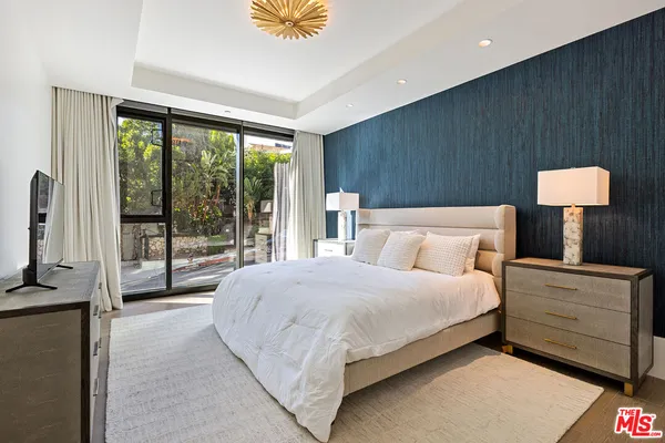 a bedroom with a bed and a lamp