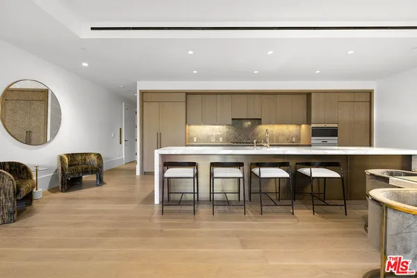 a kitchen with a sink cabinets and dining table