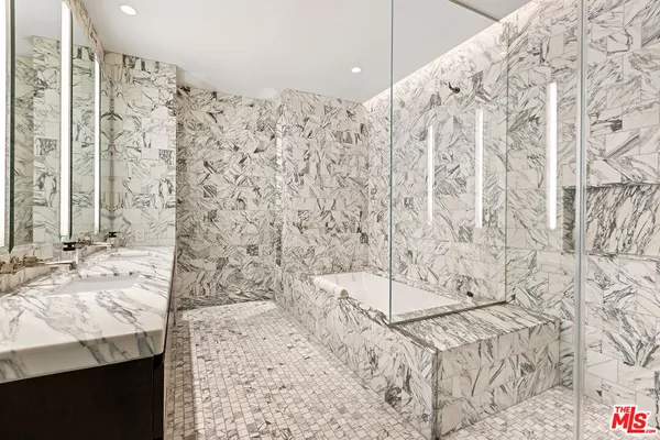 a bathroom with a bathtub sink and shower