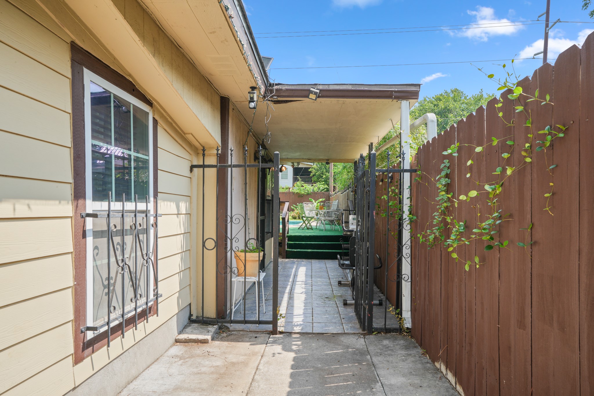 1908 Holly Street Austin, TX 78702 - Photo 2 of 22 A private side yard leads to a covered patio, ideal for relaxed outdoor moments.